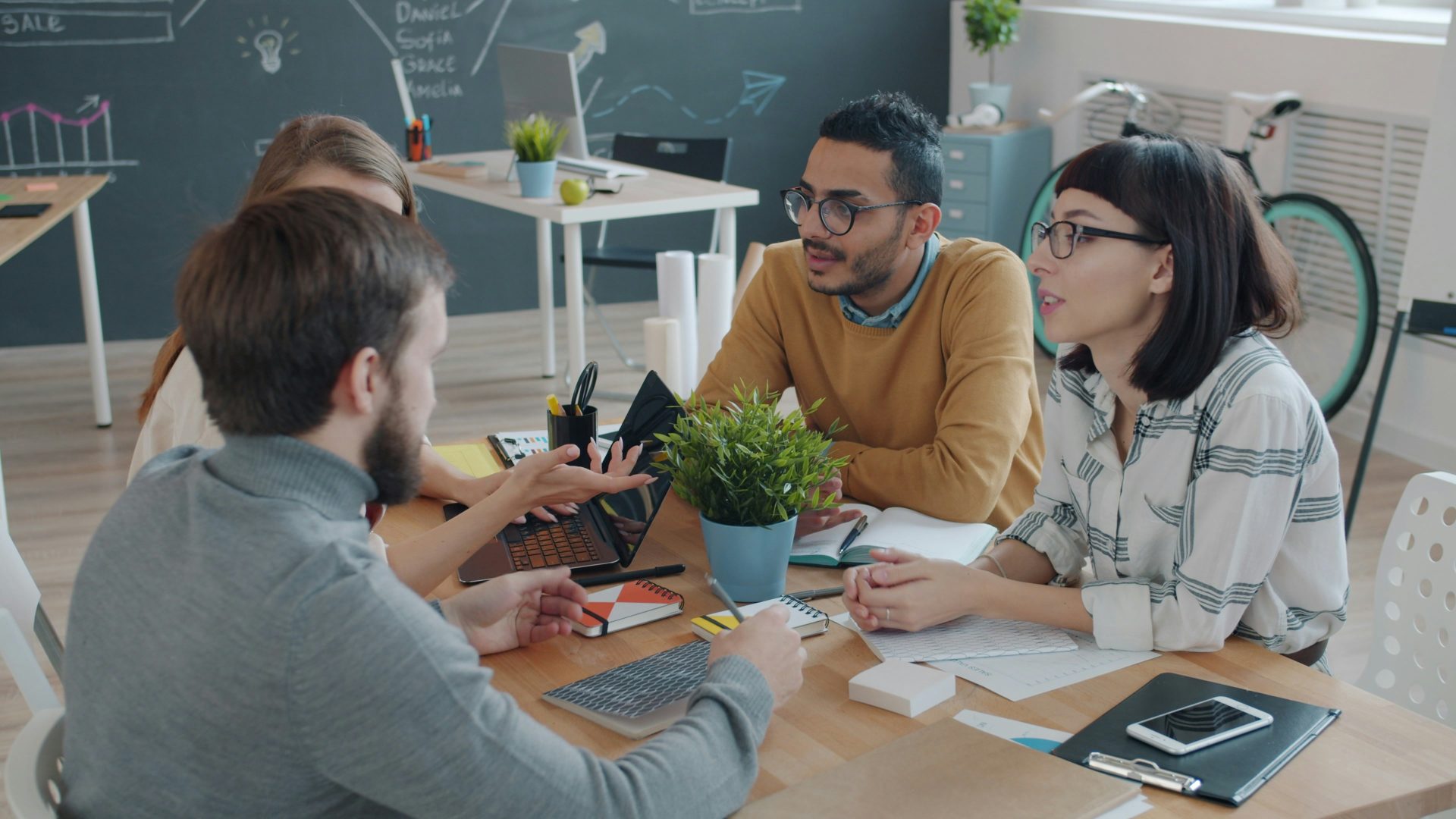 Diverse team collaborating around a table in office.